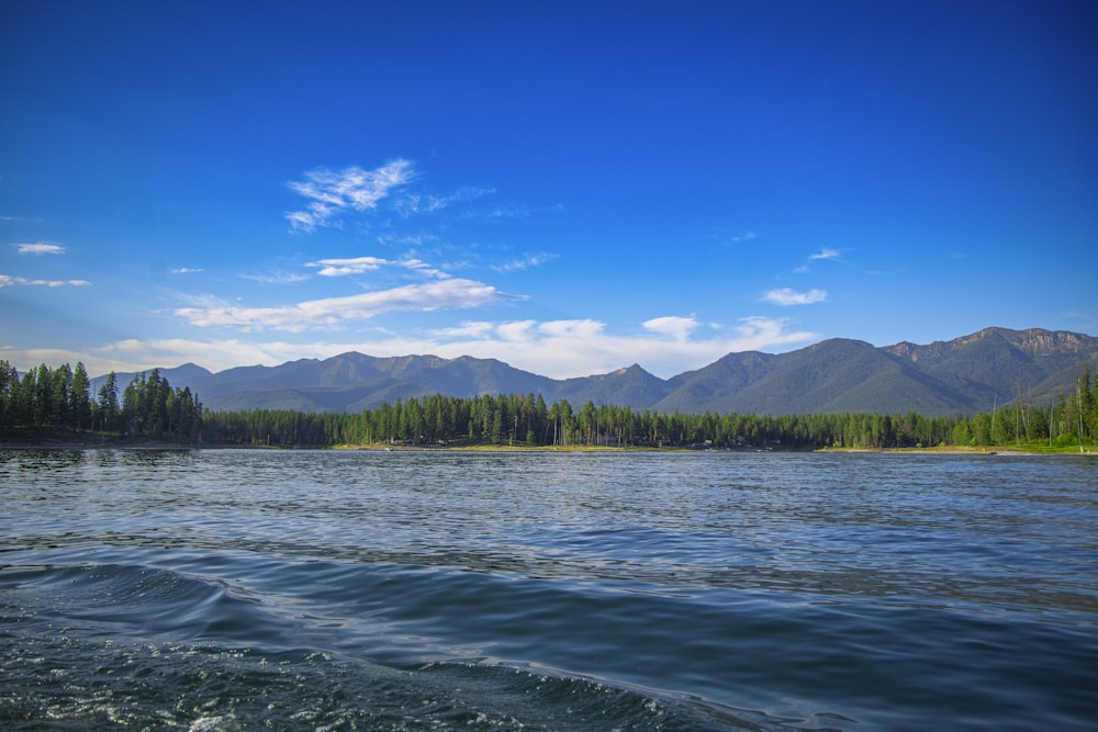 a body of water with mountains in the background