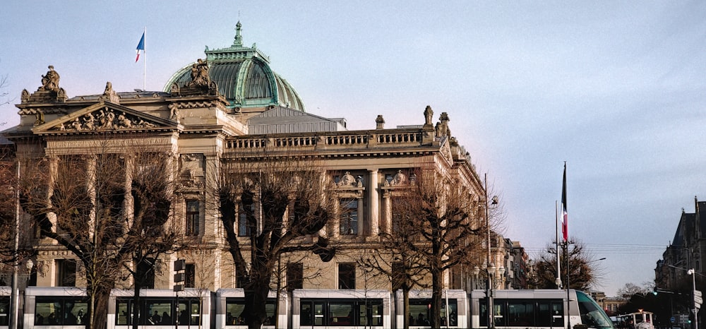 a bus is parked in front of a large building