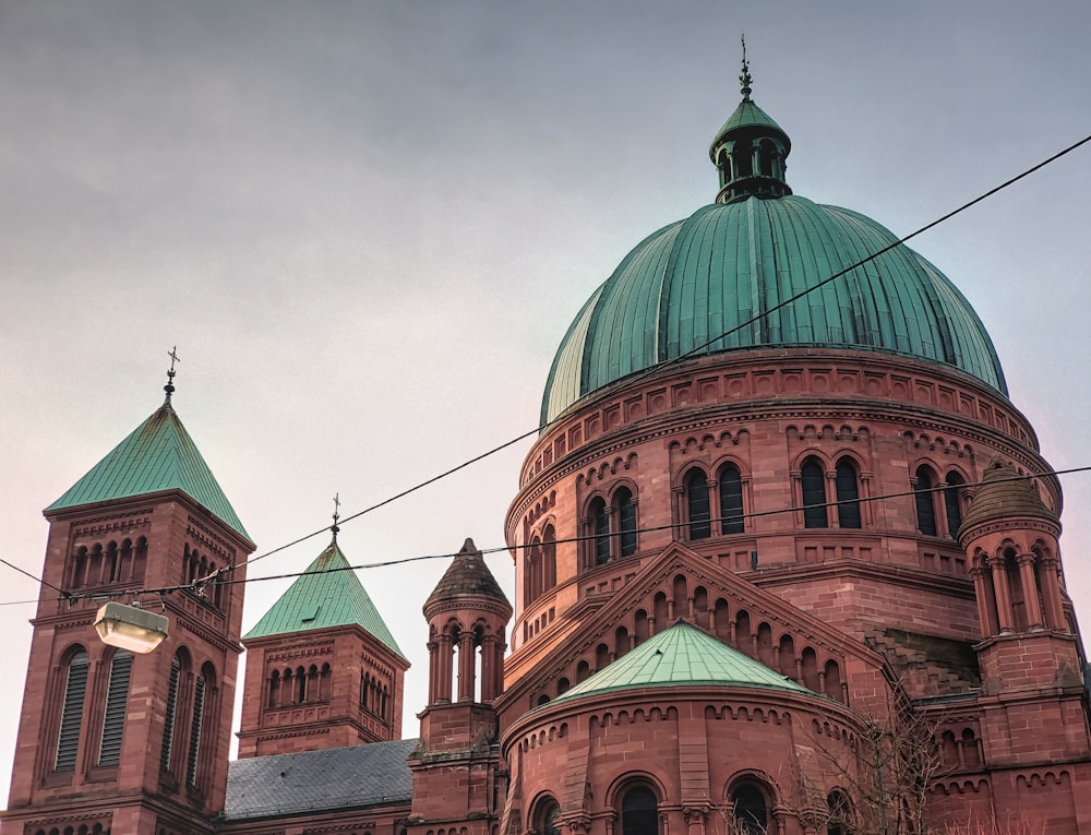 a large red building with a green dome