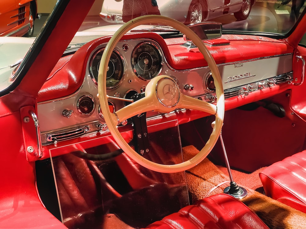 a red car with a steering wheel and dashboard