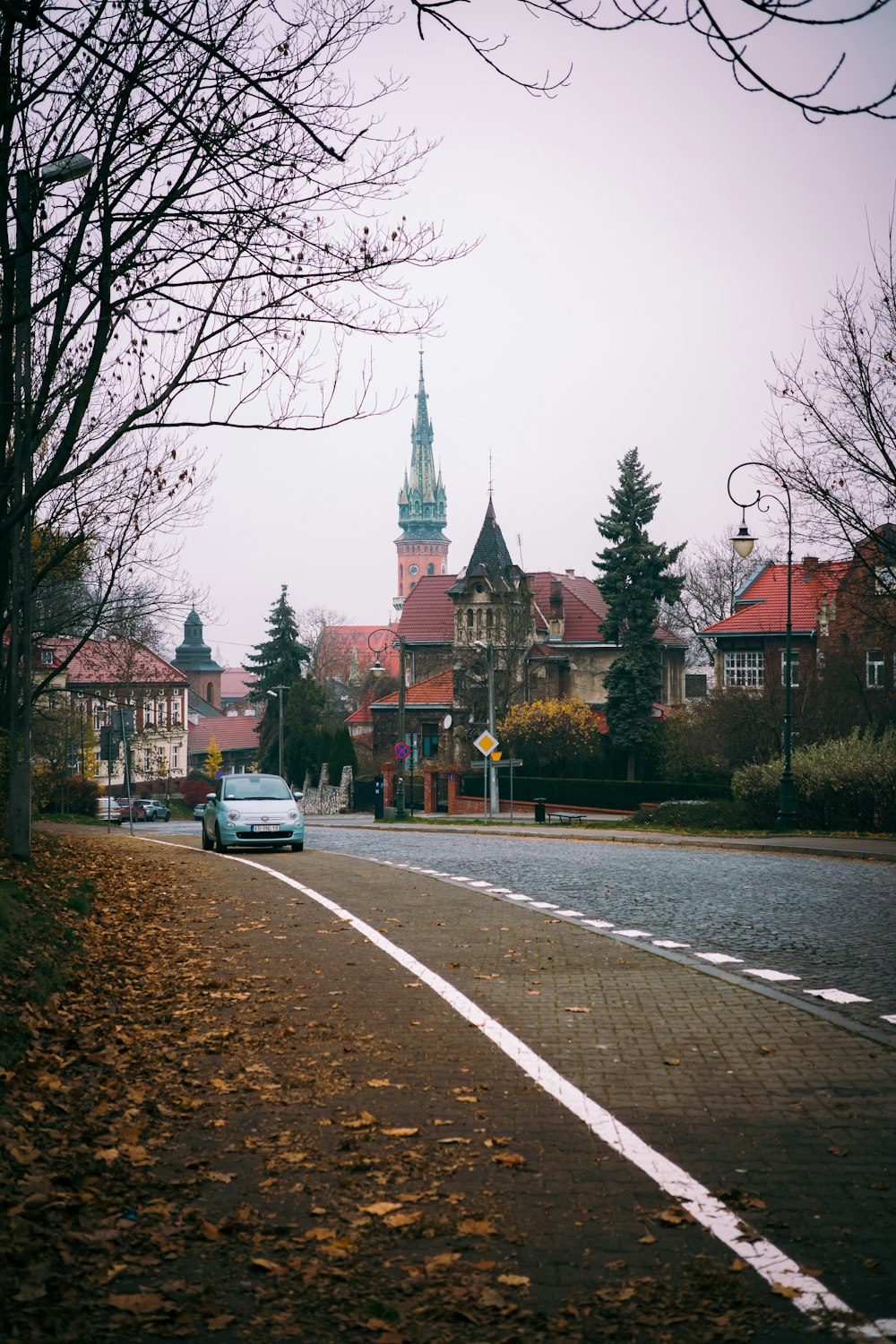 a car driving down a street next to a tall building