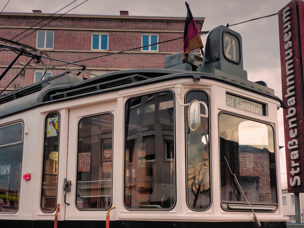 a white trolley car on a city street