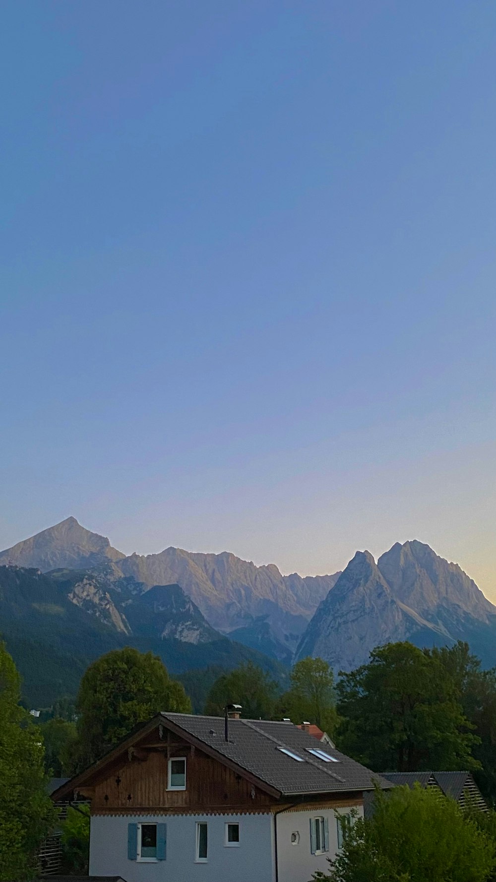 a view of a house with mountains in the background