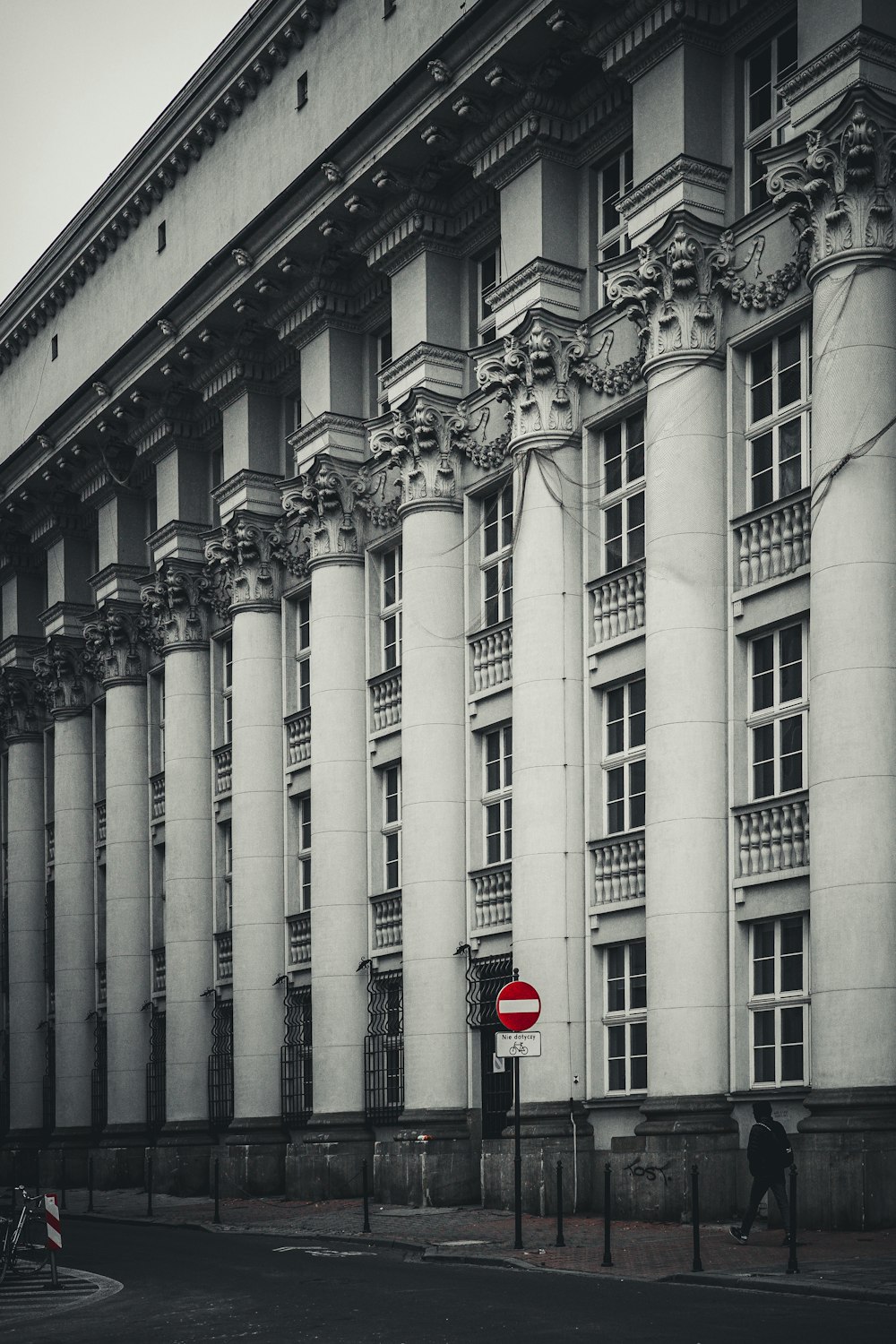 a red stop sign sitting in front of a tall building