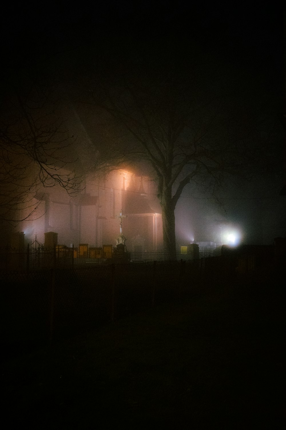 a foggy night in front of a house