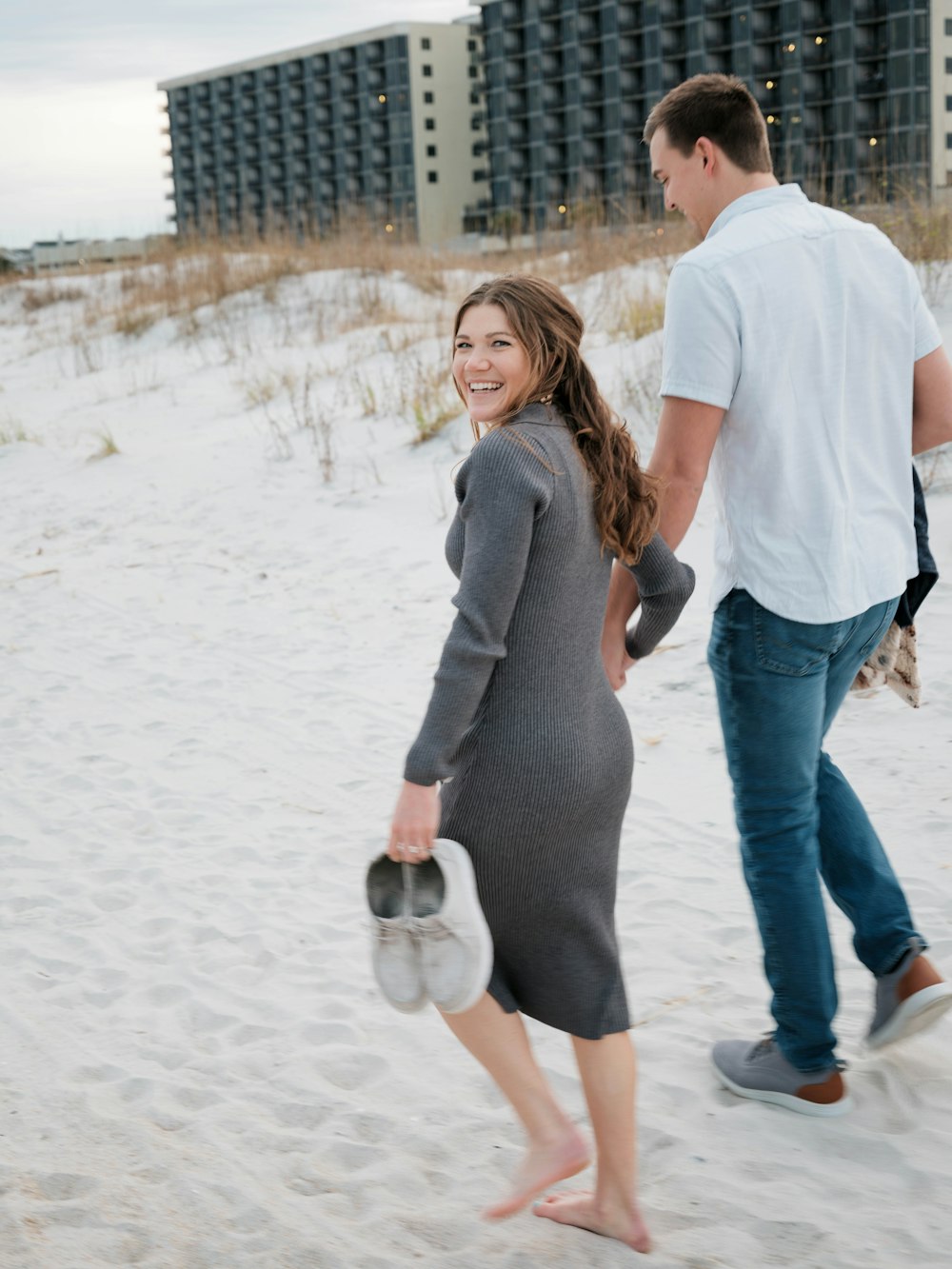 a man and a woman walking on a beach