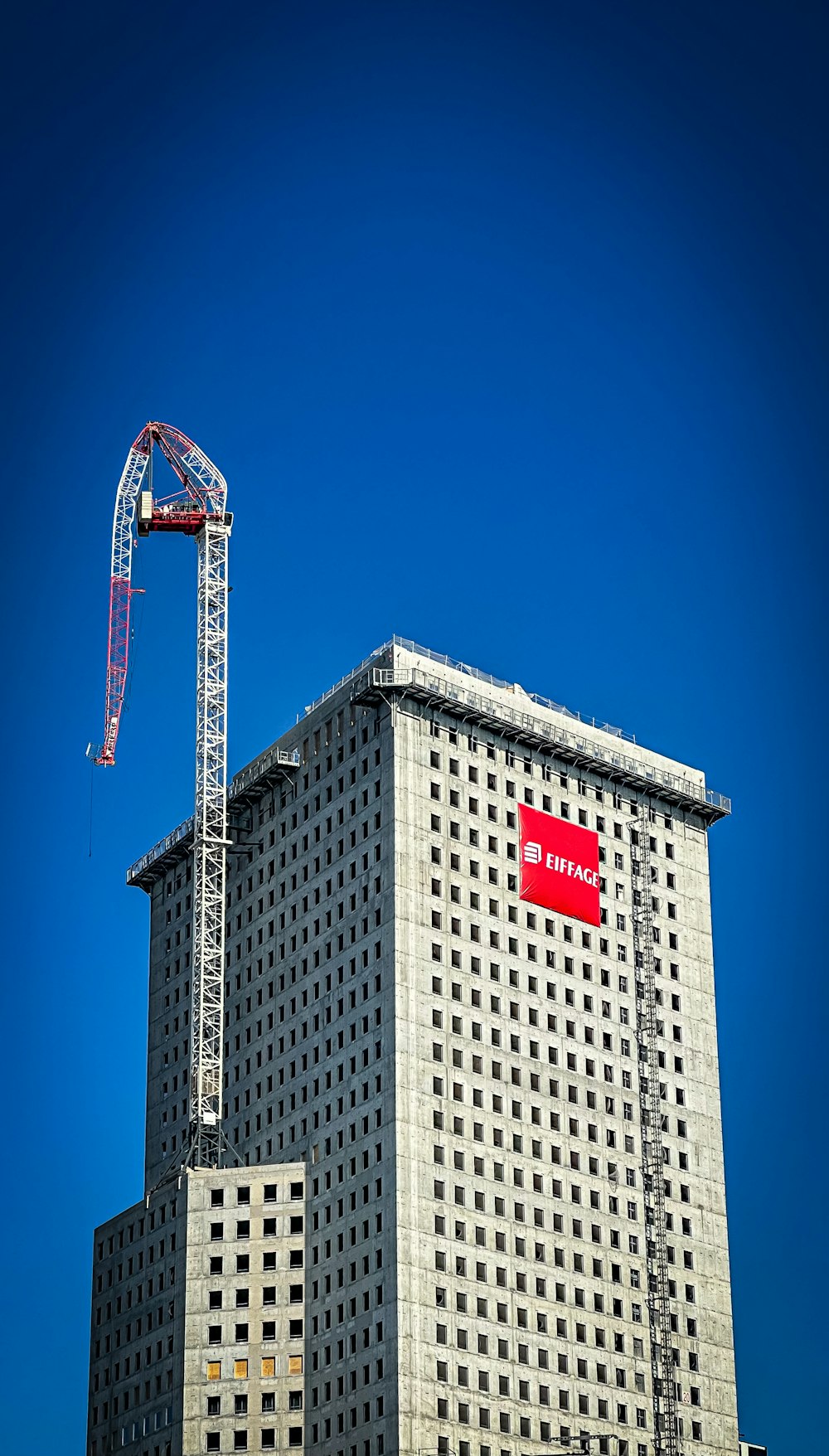 a tall building with a crane on top of it