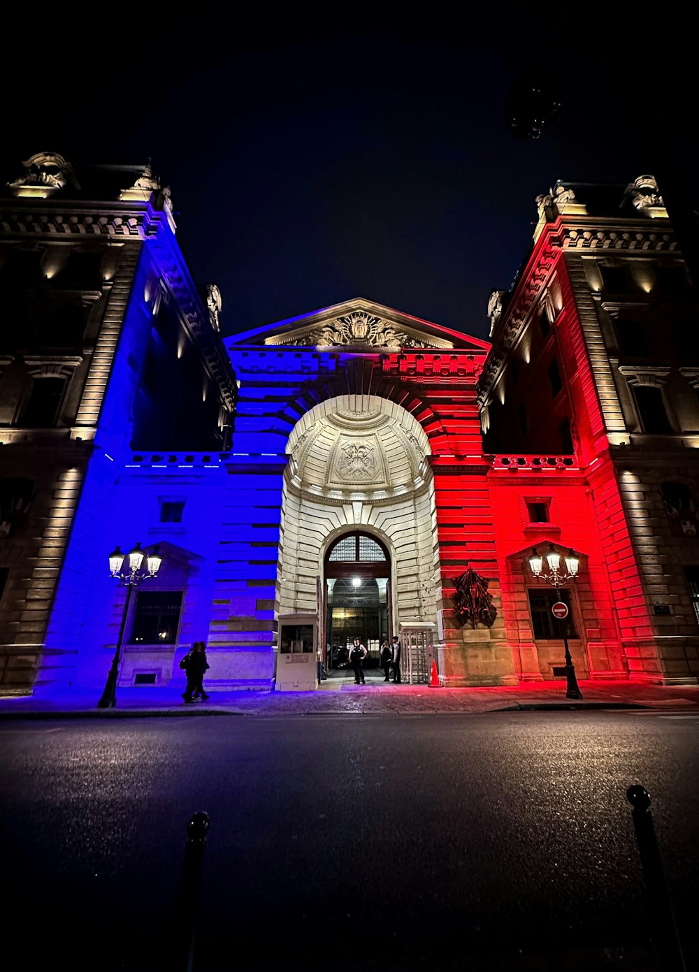 a large building with red, white and blue lights on it