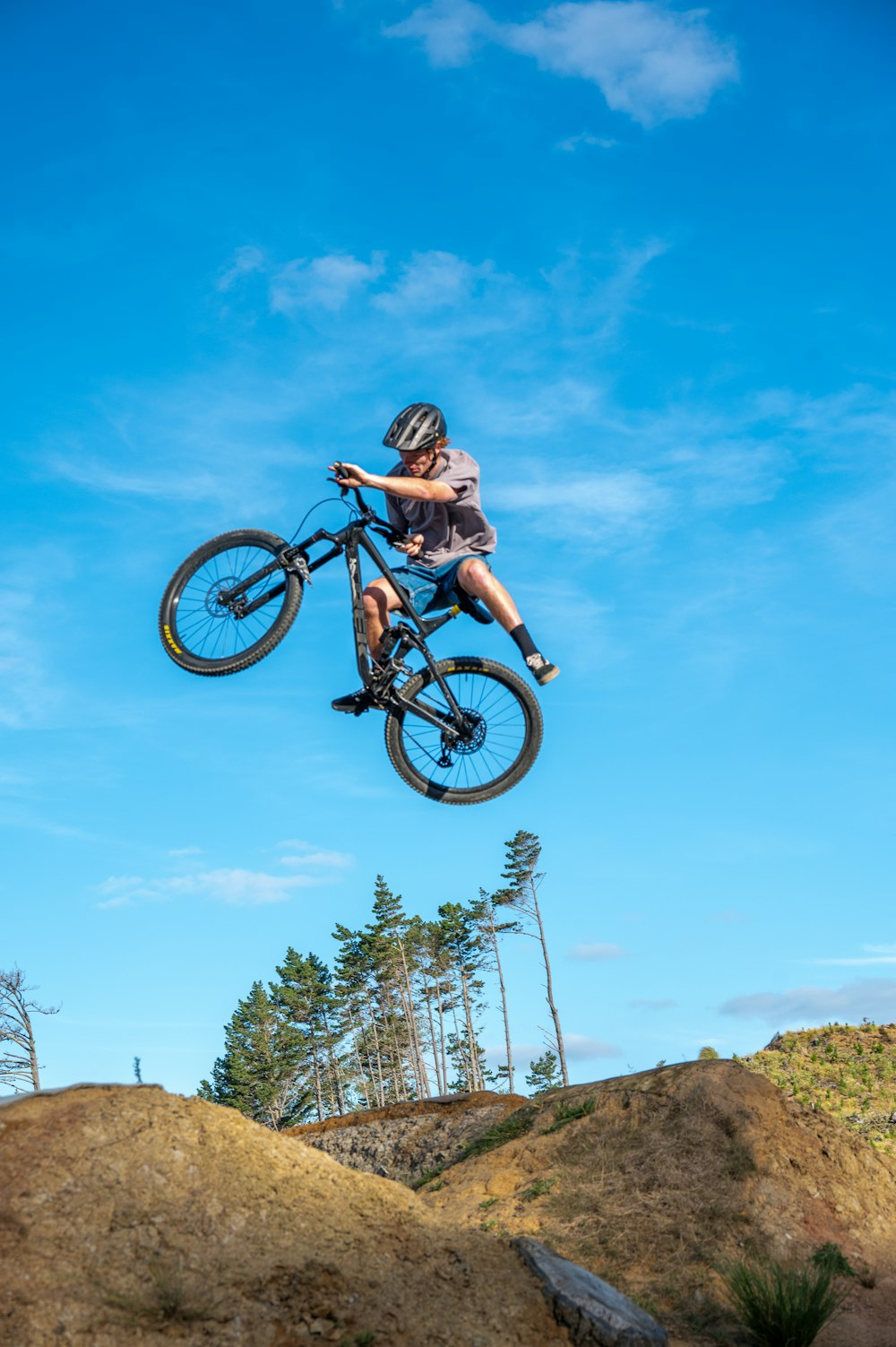 a man flying through the air while riding a bike