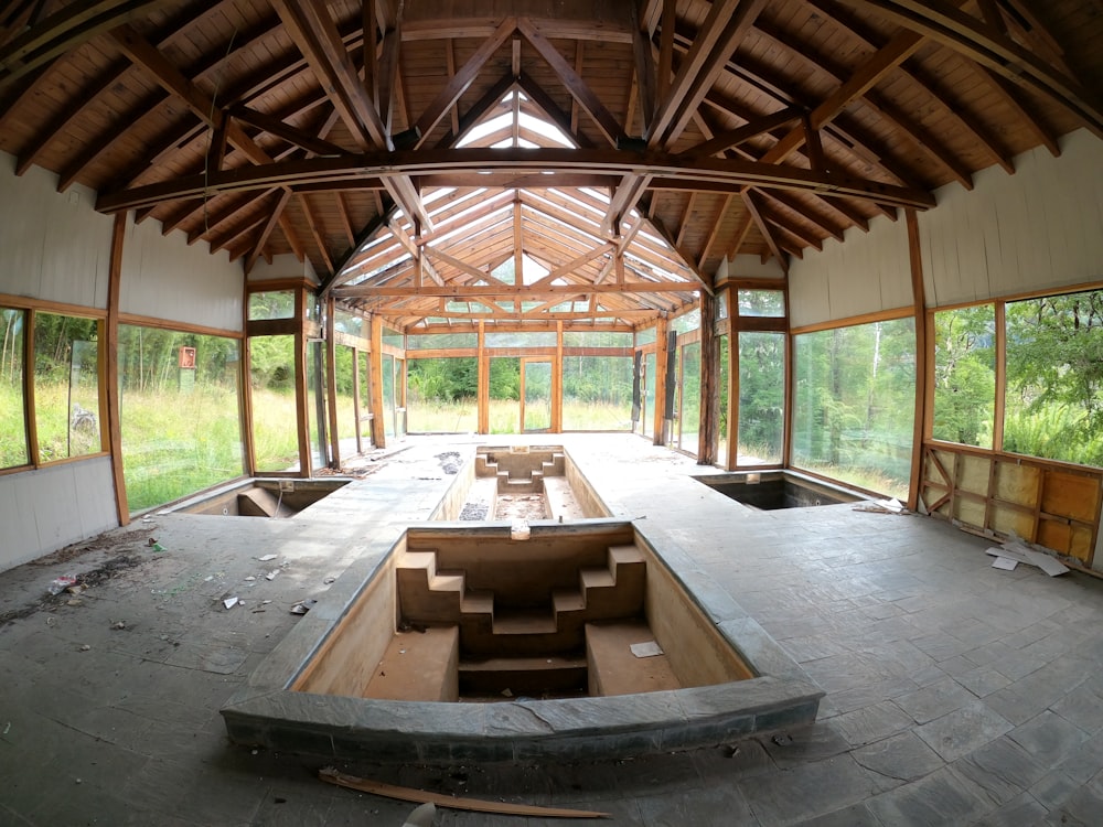 an empty room with benches and windows in it