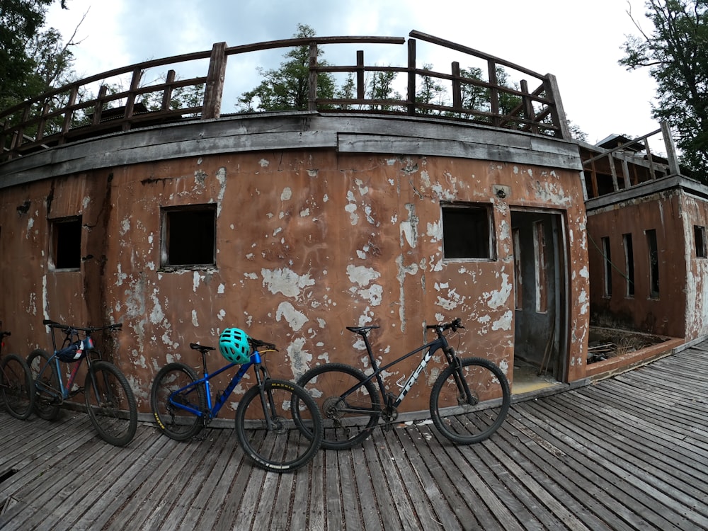 three bikes are parked in front of an old building