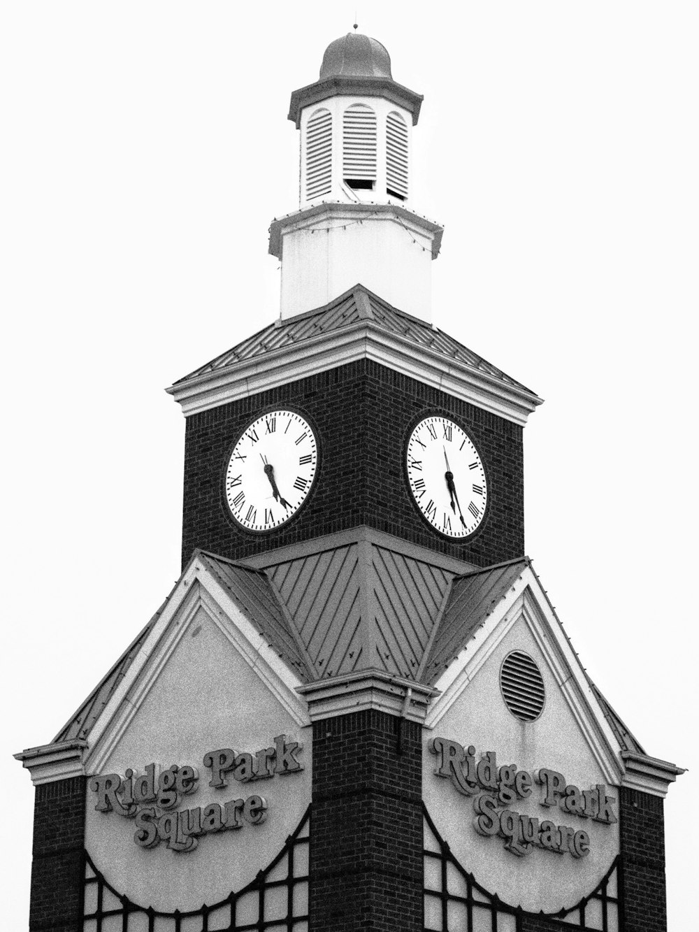 a black and white photo of a clock tower