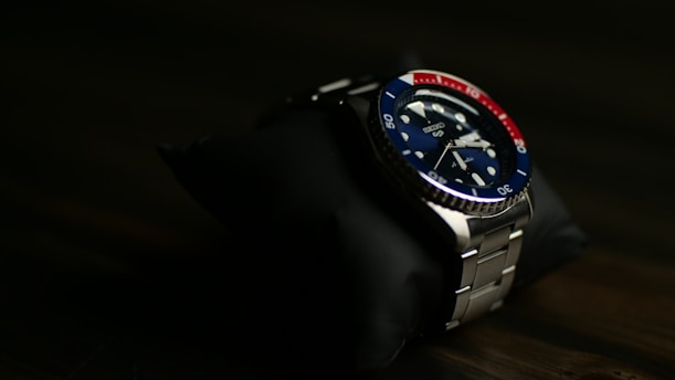 a watch sitting on top of a black cloth