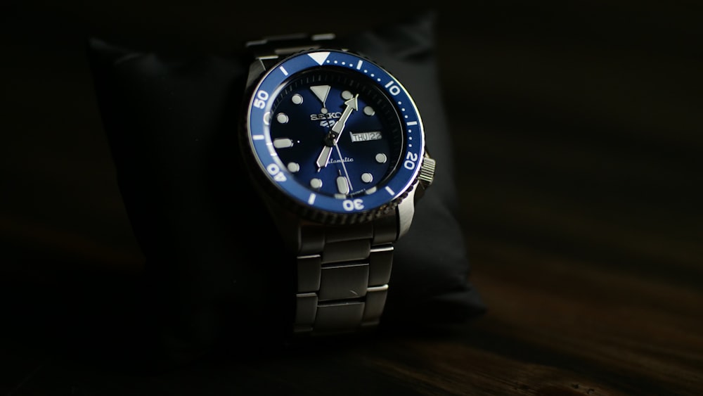 a blue and black watch sitting on a table