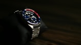 a watch sitting on top of a black cloth