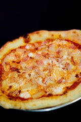 a pizza sitting on top of a metal pan
