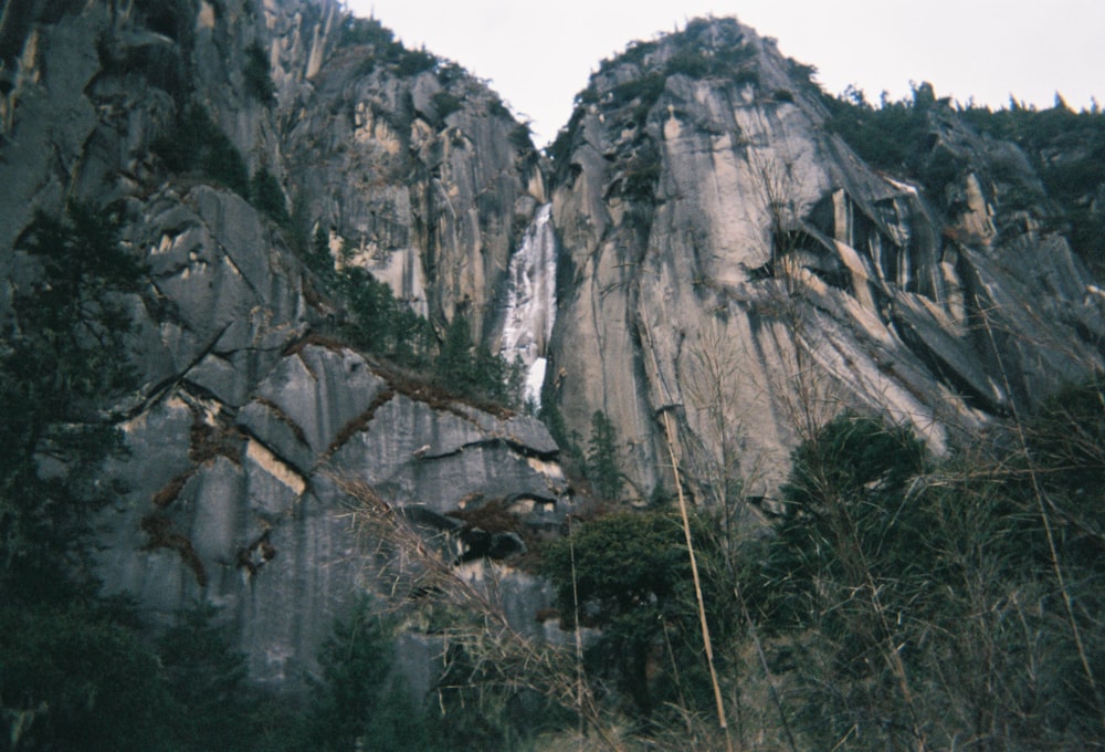 a very tall mountain with a waterfall coming out of it