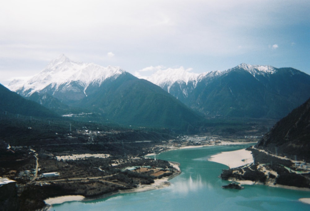 an aerial view of a lake surrounded by mountains