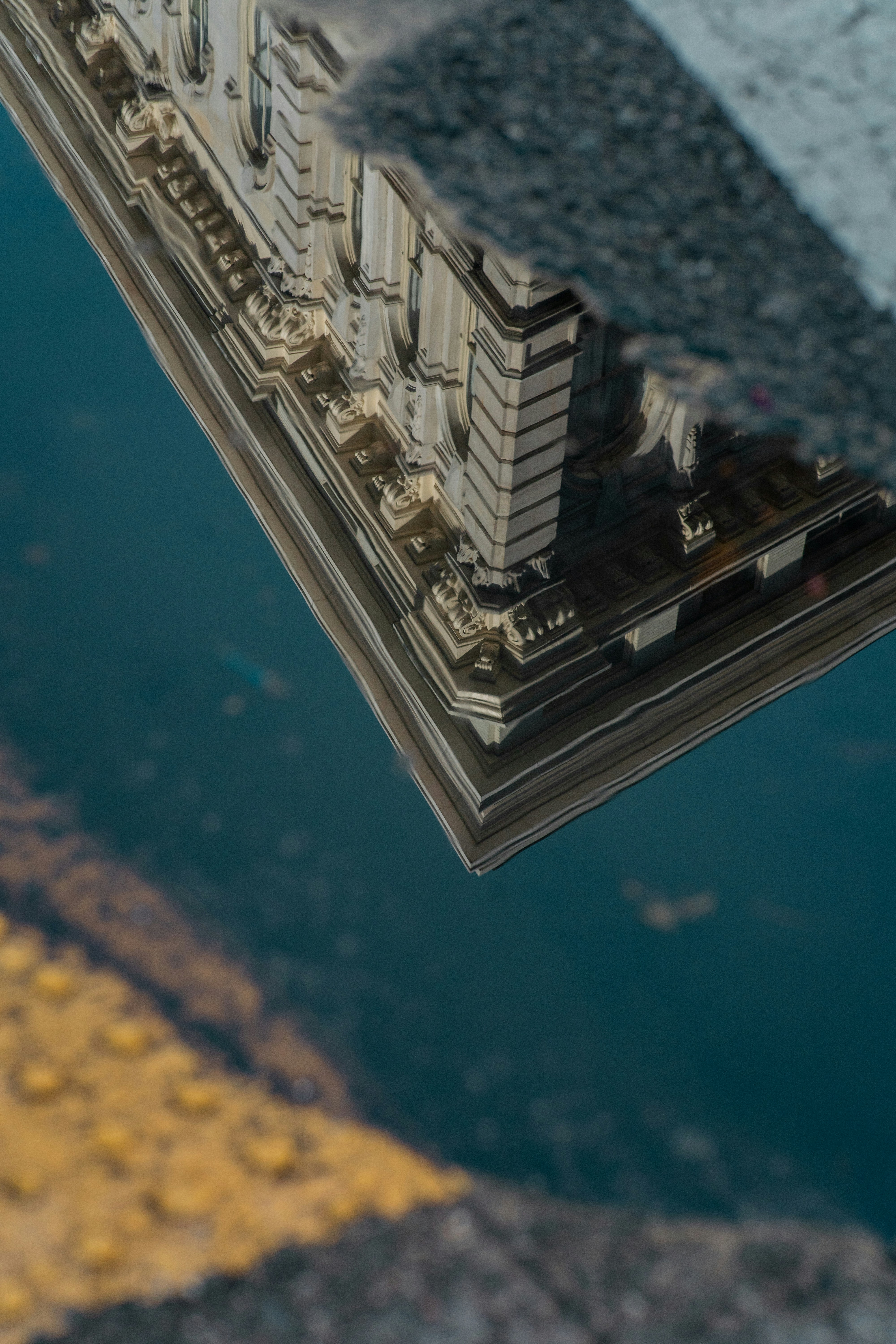 A reflection of a building in a puddle of water photo – Free Building ...