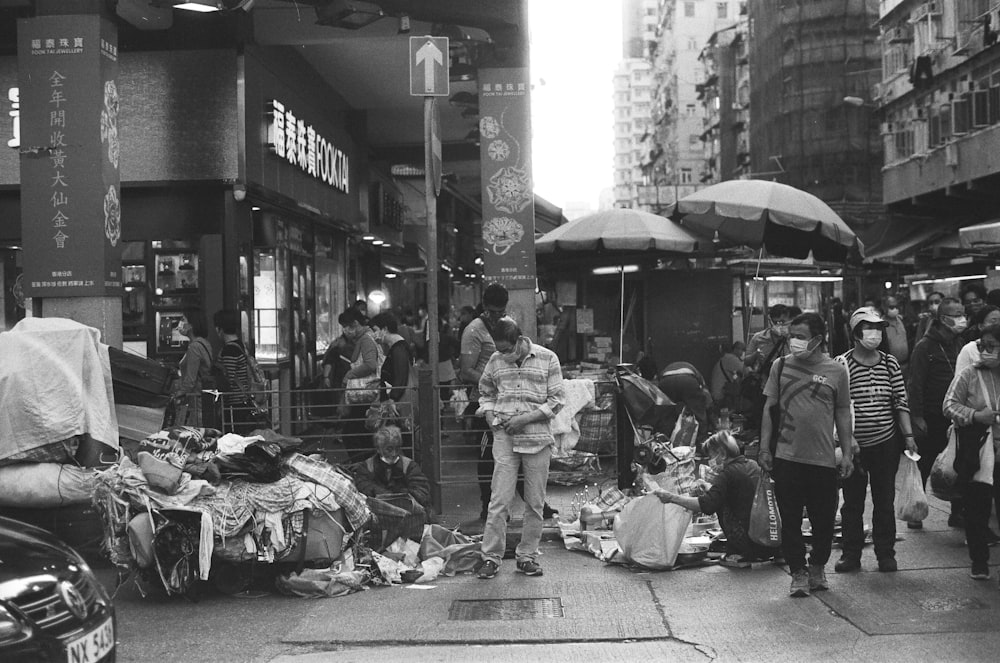 a black and white photo of a crowded street