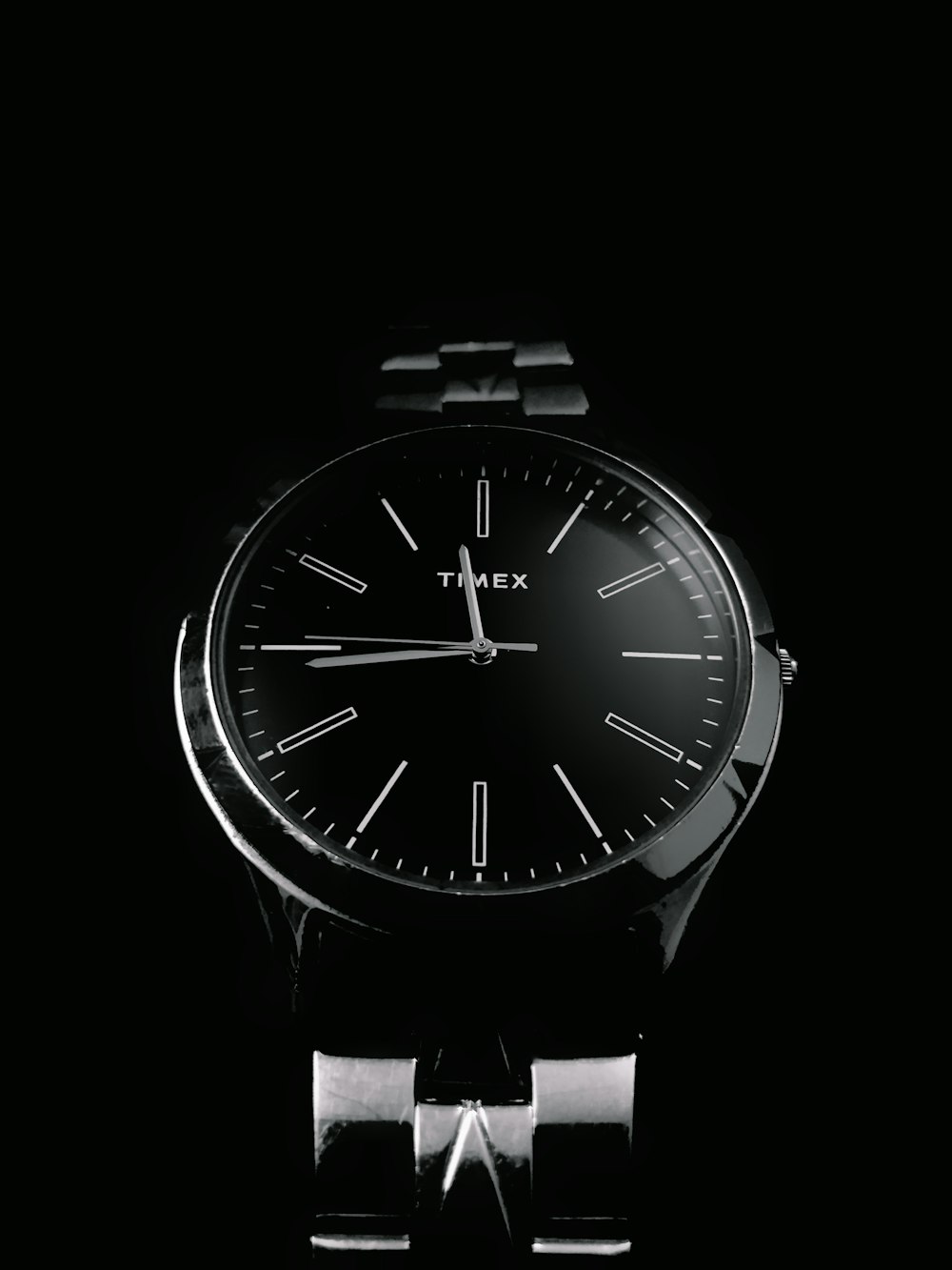 a close up of a watch on a black background