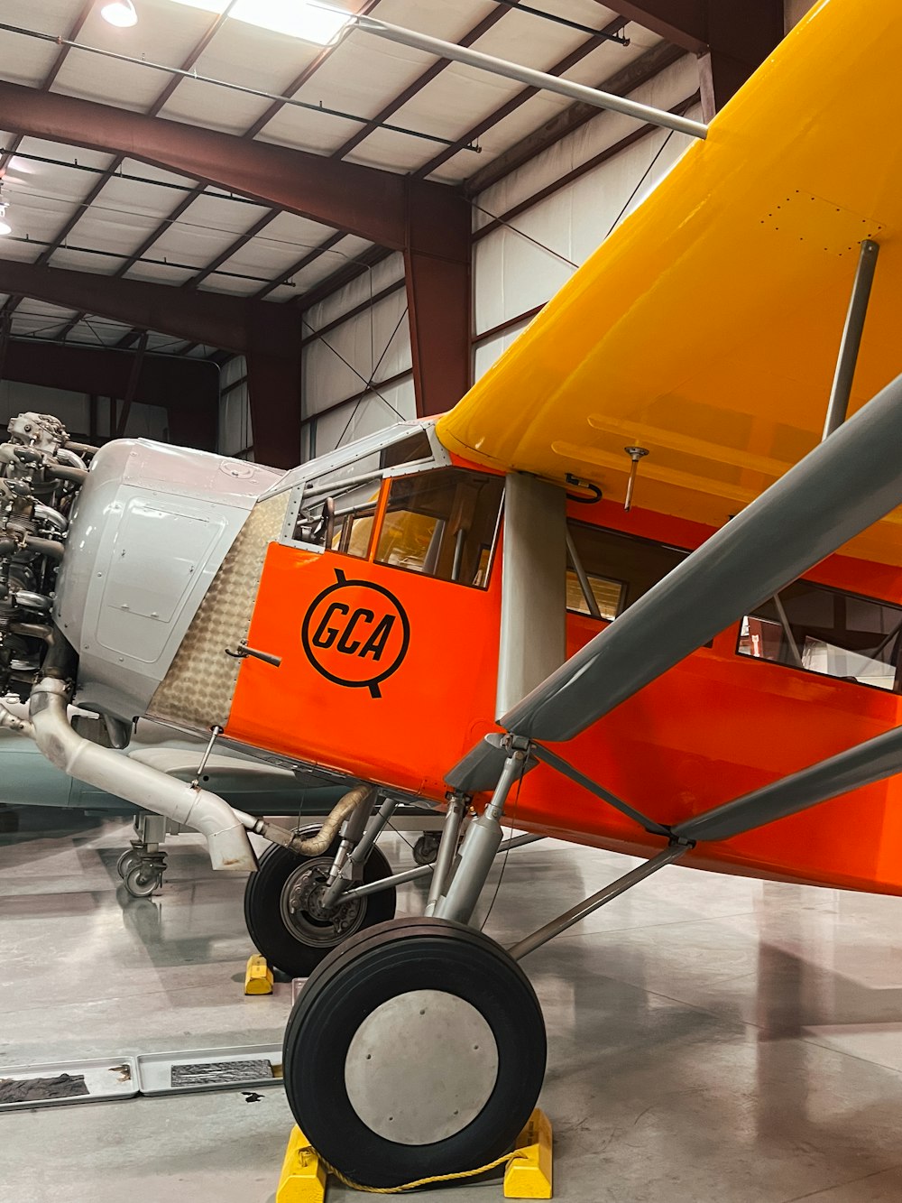 an orange and white airplane in a hanger