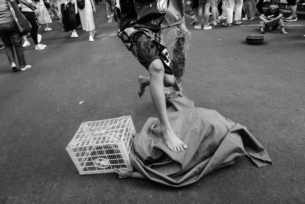 a group of people standing around a person laying on the ground