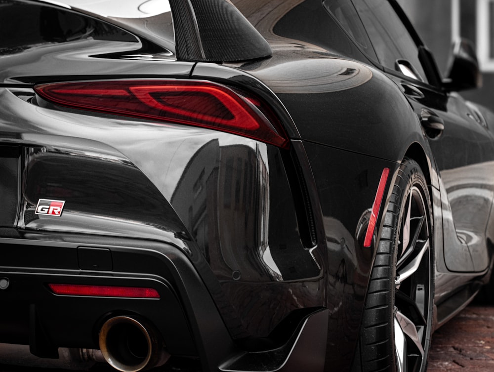 the rear end of a black sports car