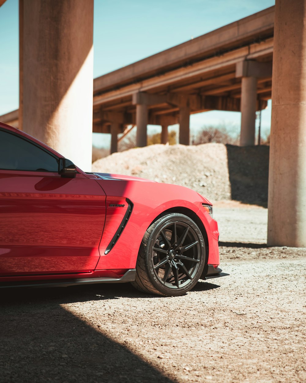 a red sports car parked in a parking lot