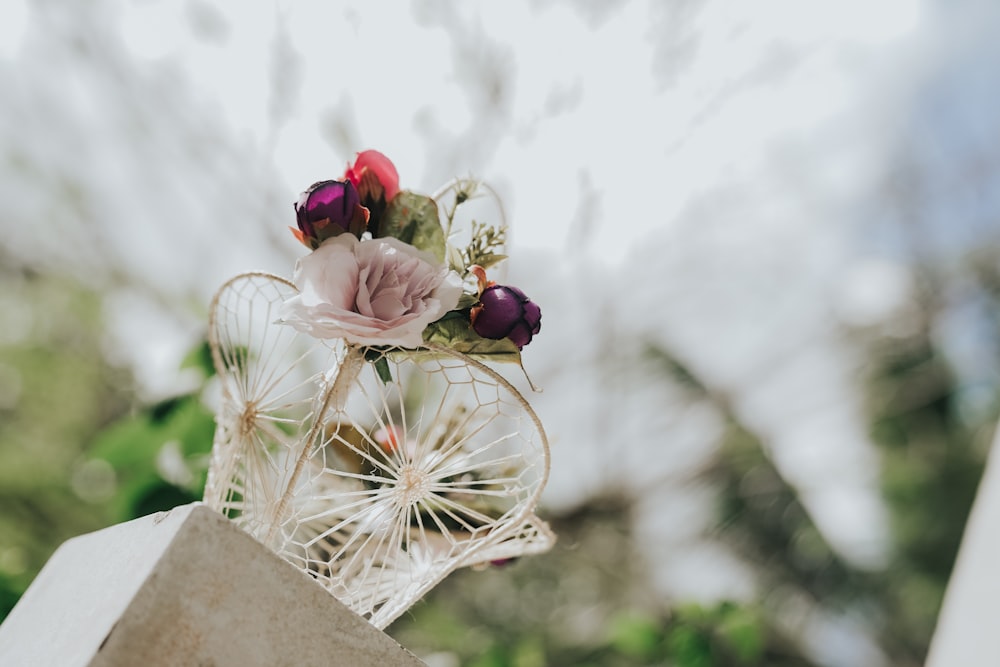 a close up of a vase with flowers in it