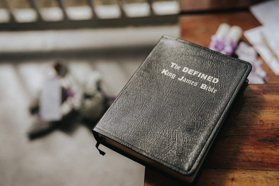 a black book sitting on top of a wooden table