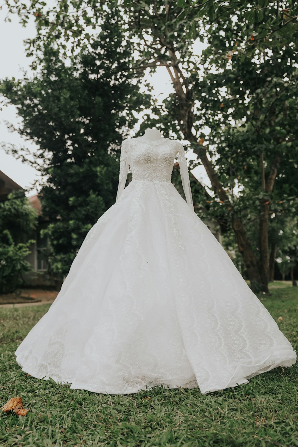 a wedding dress on display in the grass