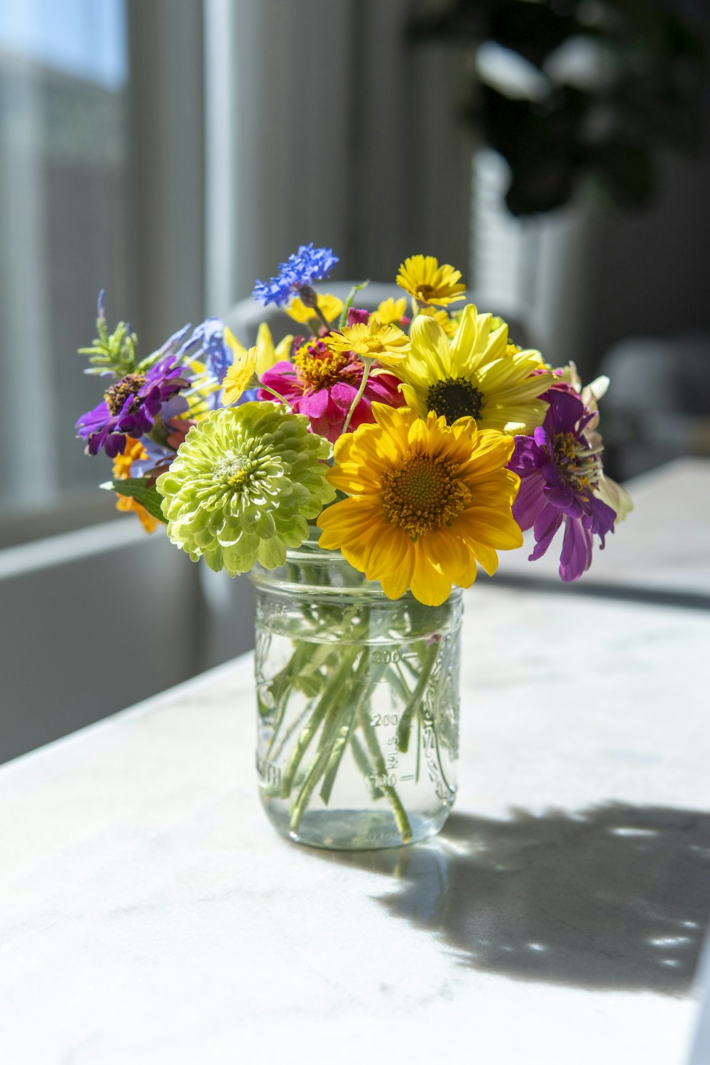 a vase filled with lots of colorful flowers