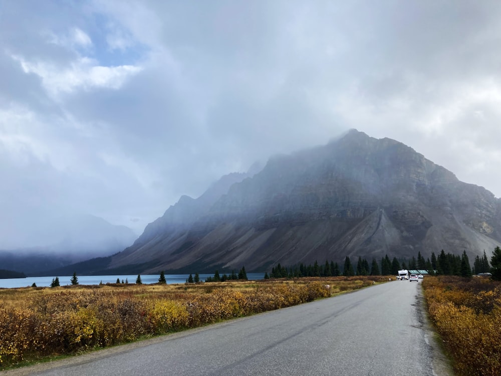 a long road with a mountain in the background