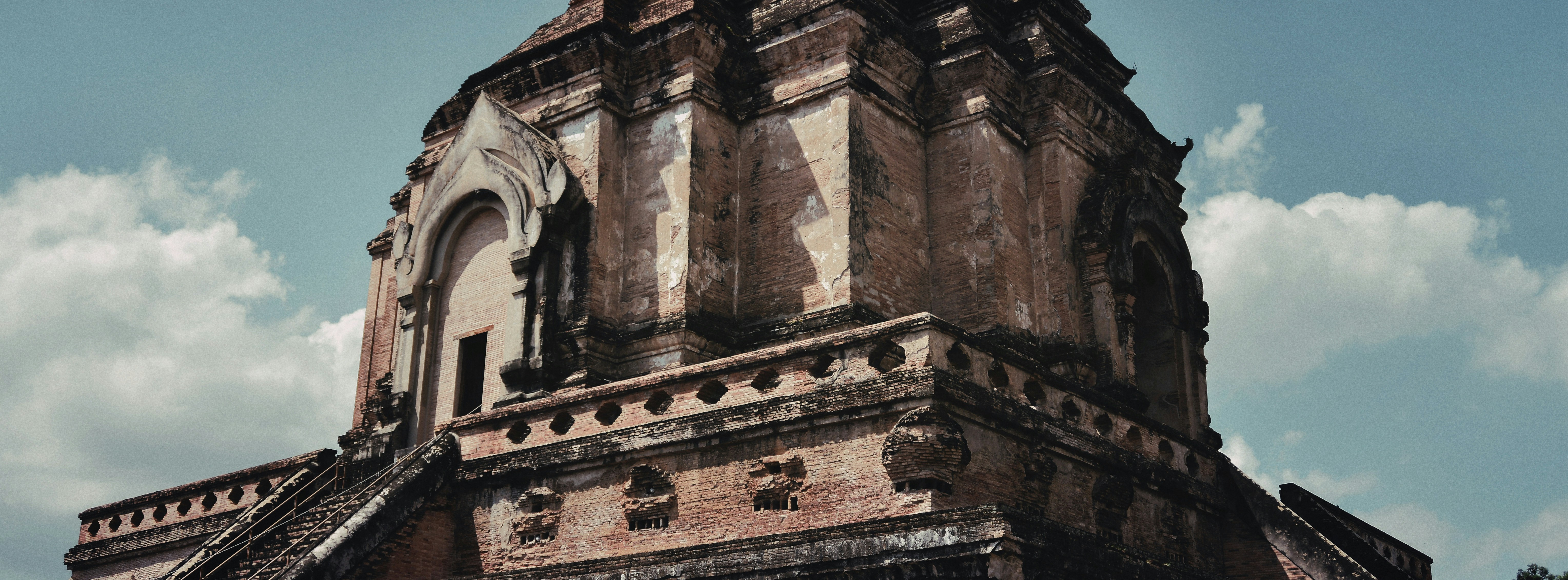 a very tall tower with a clock on it's side