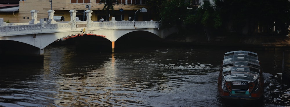 a boat is going under a bridge on a river