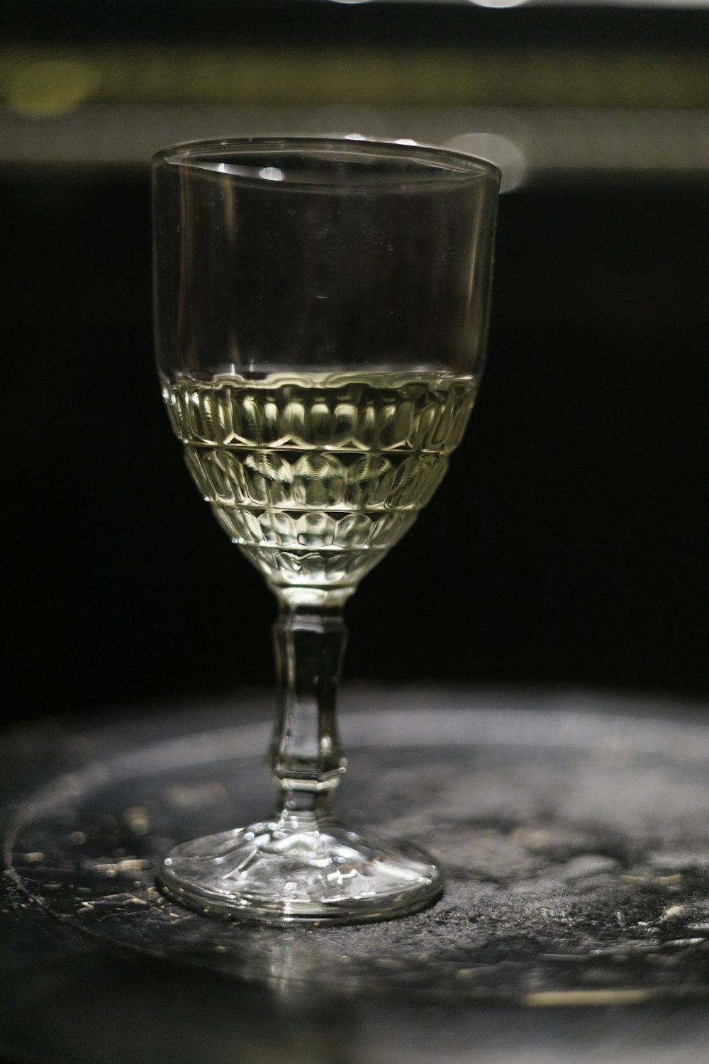 a wine glass sitting on top of a table