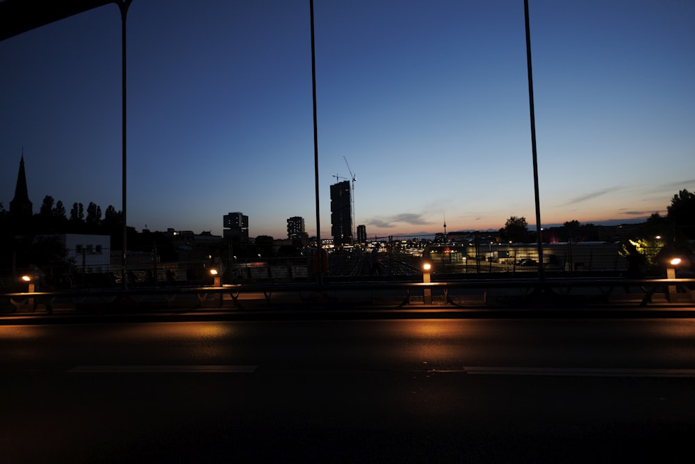 a view of a city at night from a bridge