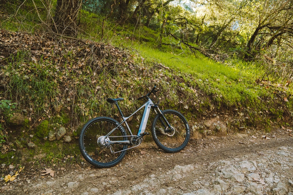 a mountain bike parked on a dirt road