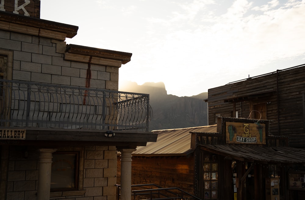 a building with a balcony and mountains in the background