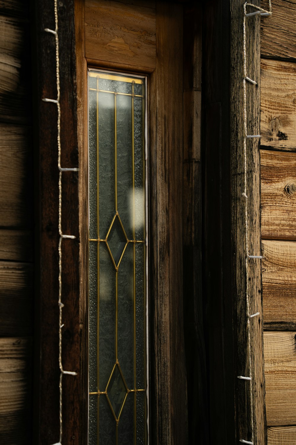 a close up of a wooden door with glass