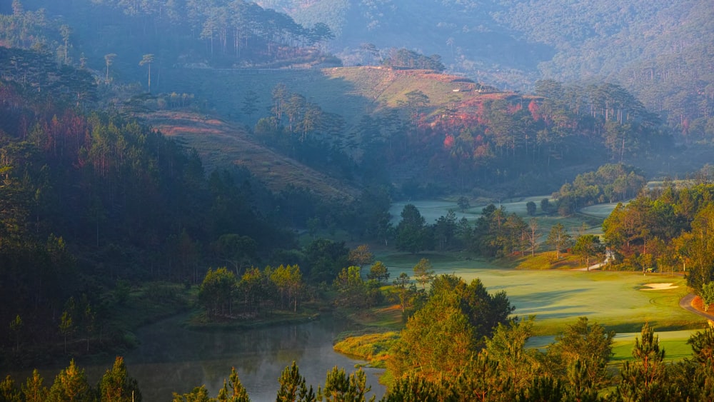 a scenic view of a golf course in the mountains