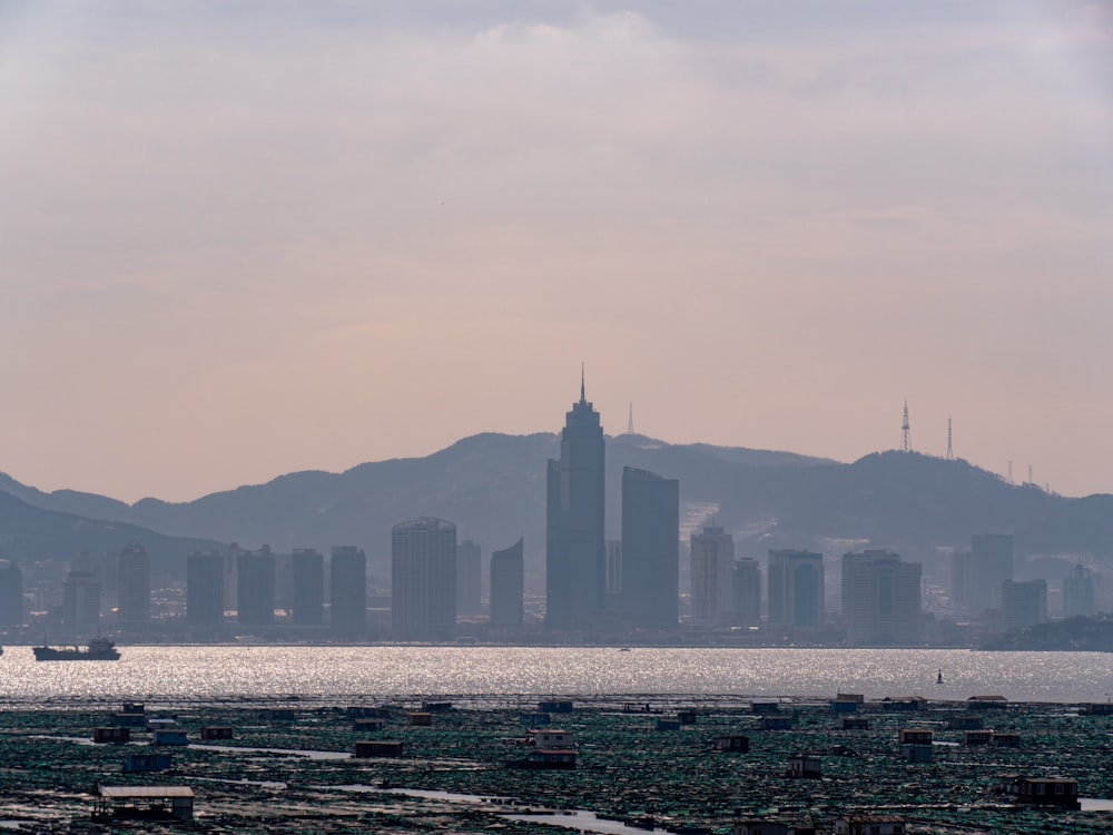 a large body of water with a city in the background