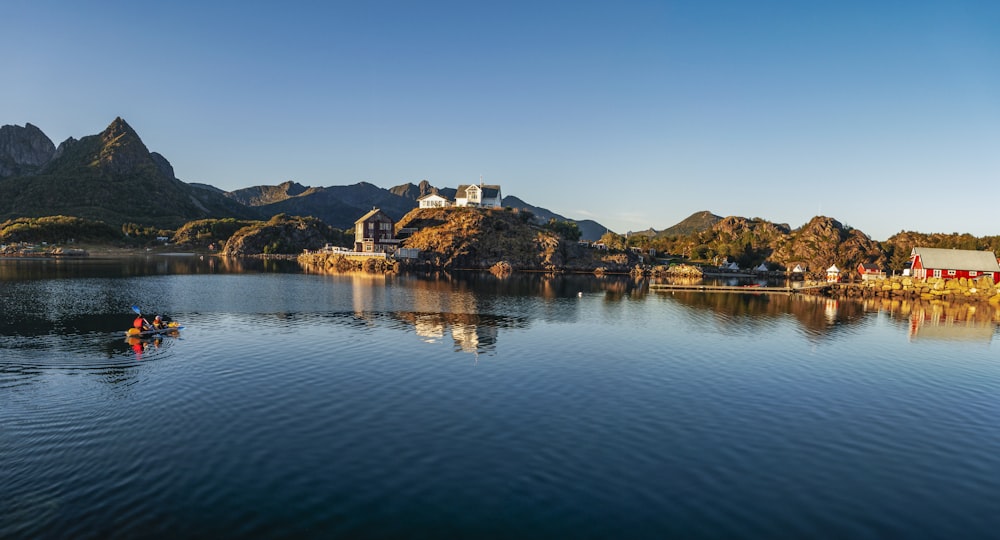 a small boat floating on top of a lake