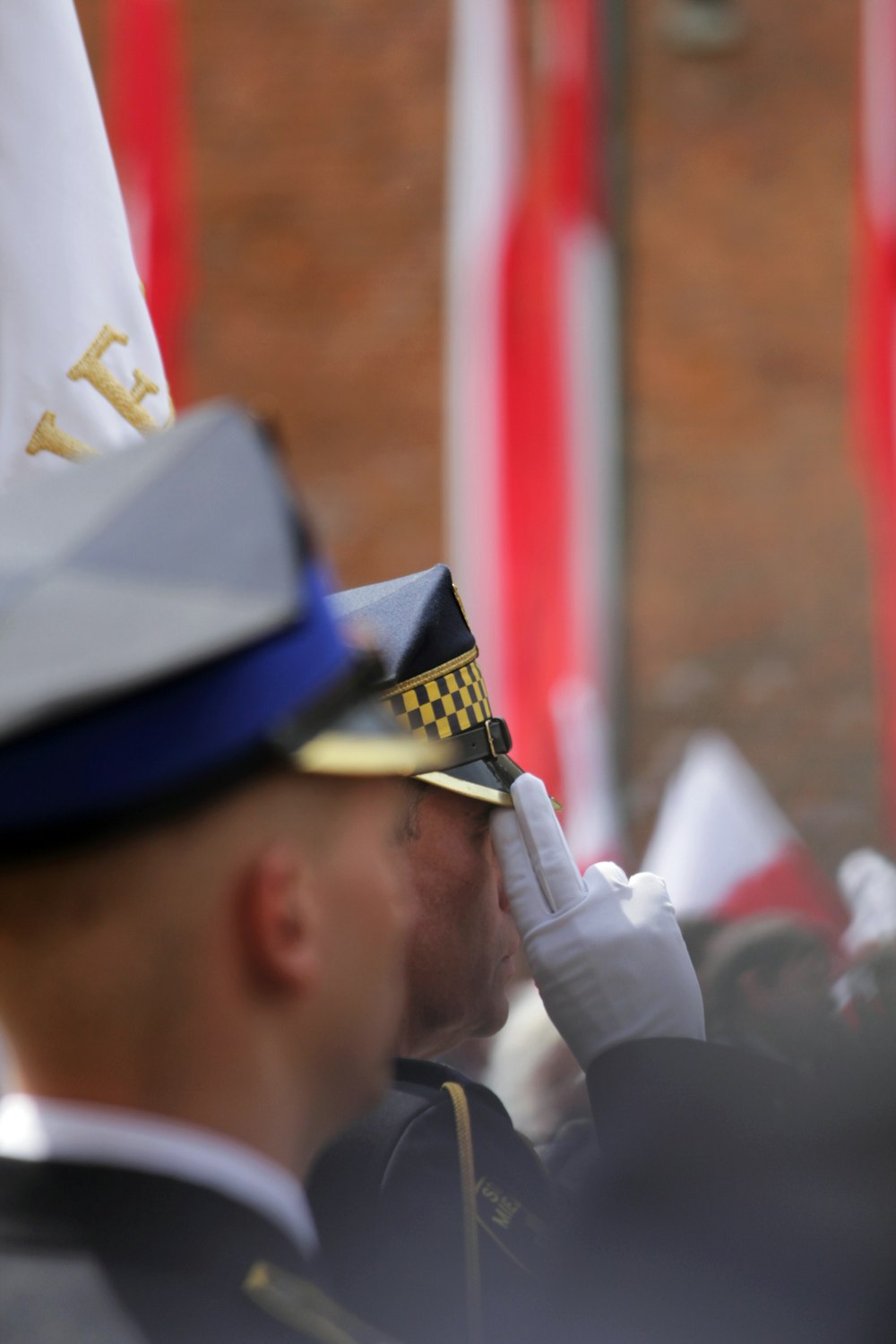 a man in a uniform saluting a crowd of people