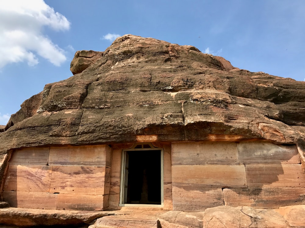 a large rock formation with a window in it