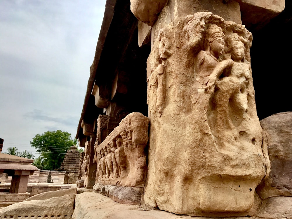 a stone sculpture of a man and a woman