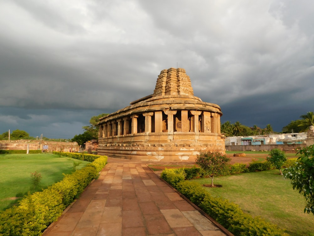 a large stone structure sitting on top of a lush green field