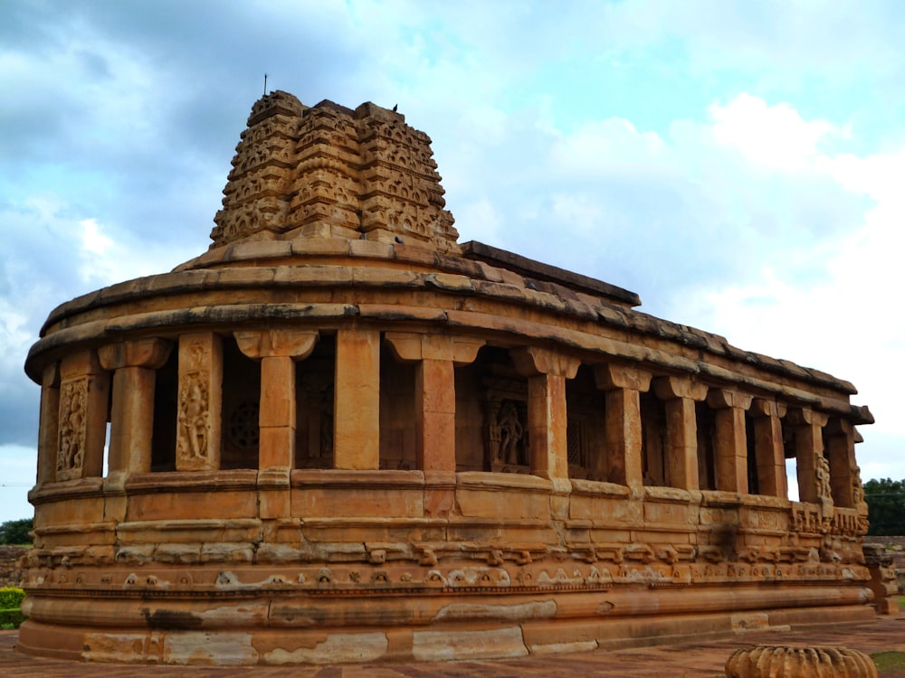 a large stone structure sitting on top of a dirt field