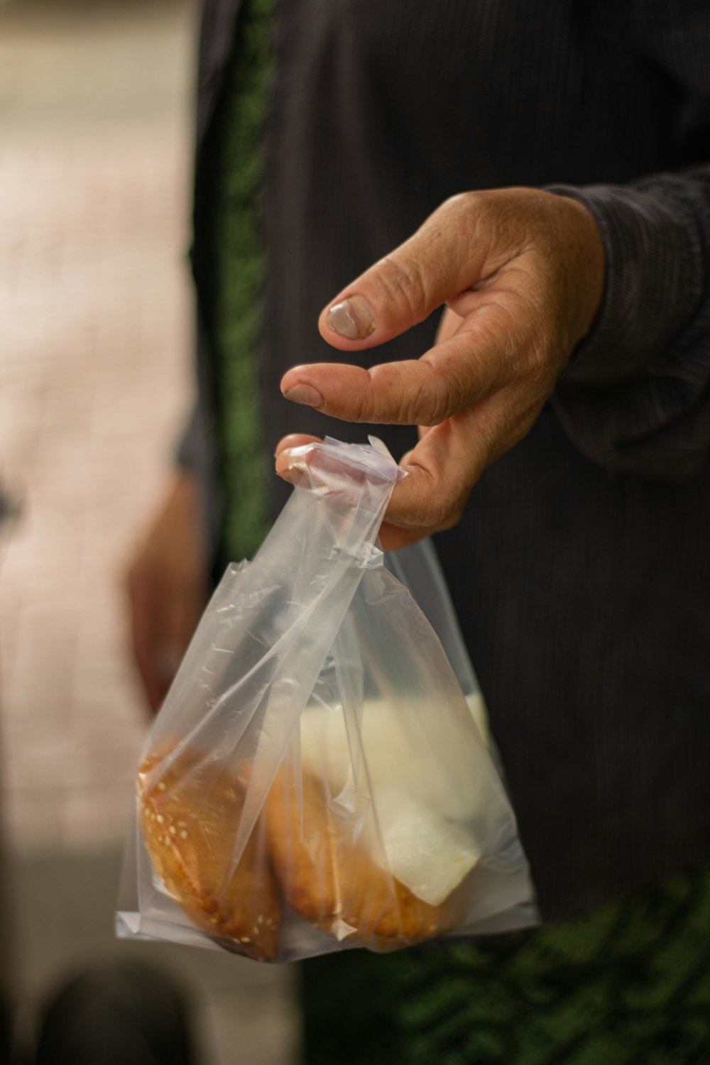 a person holding a bag of food in their hand
